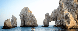 the arch of cabo san lucas mexico with a boat in the water