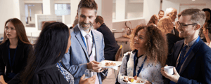 group of event attendees eating lunch at a conference