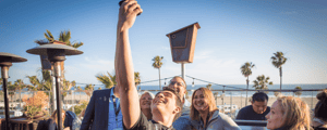 group of event attendees taking a selfie during a sales kickoff meeting