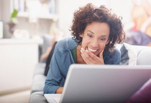 event planner woman smiling at computer