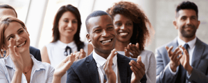 group of event attendees clapping after a conference presentation