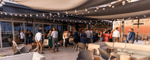 group of attendees networking on a rooftop bar event venue