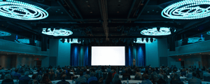 group of attendees watching a conference presentation