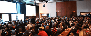 group of attendees watching a corporate conference presentation