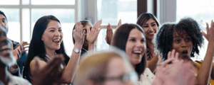 group of event attendees celebrating during a corporate conference