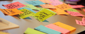 multi colored sticky notes with several notes written in dark ink