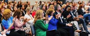 group of attendees watching a corporate conference