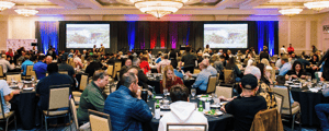 group of attendees watching a presentation at a corporate conference