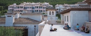 group of people practicing yoga on balcony of resort in Mallorca for luxury incentive trip