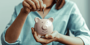 woman saving money in a piggy bank