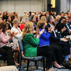 group of event attendees watching a conference presentation