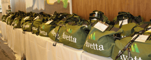 conference swag bags on table with Avetta logo