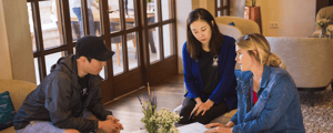 event manager talking with two event attendees about the agenda