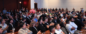 group of event attendees watching a conference